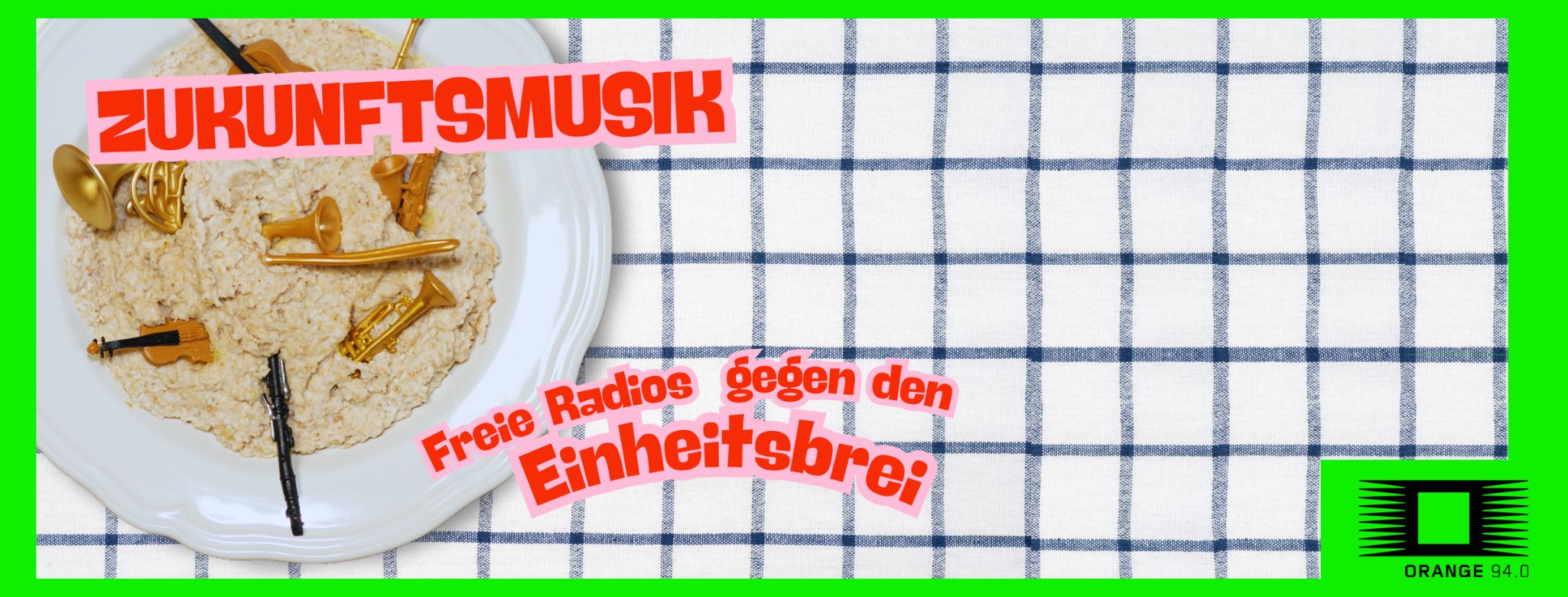 checkered table cloth with a cup of porridge containing a number of music instruments. Text: Zukunftsmusik - Freie Radios gegen den Einheitsbrei